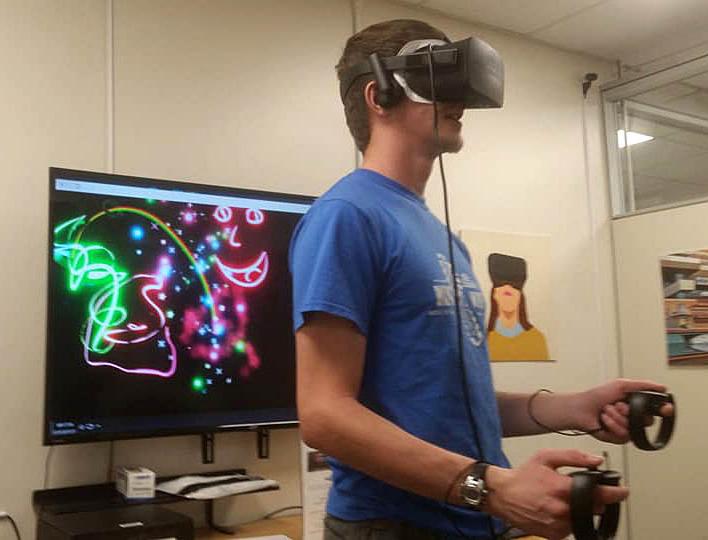 A student works on art using virtual reality equipment